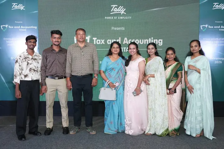 The Skylite Technologies team together in front of the Tally event backdrop in Shivamogga.