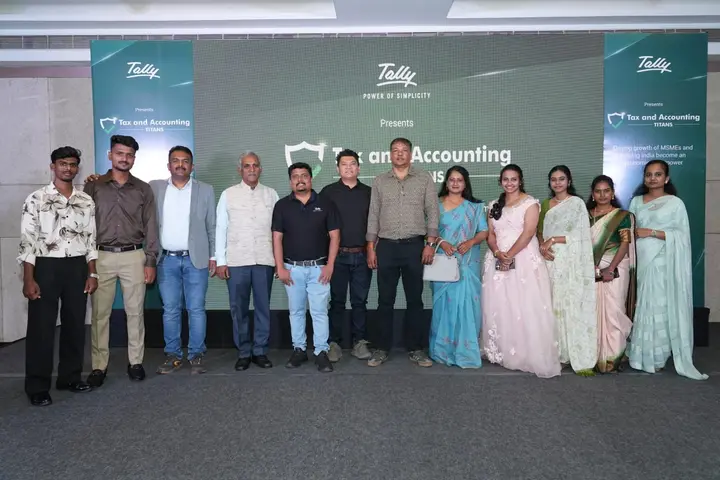 A wider group photo of the team and guests at the same Tally event.